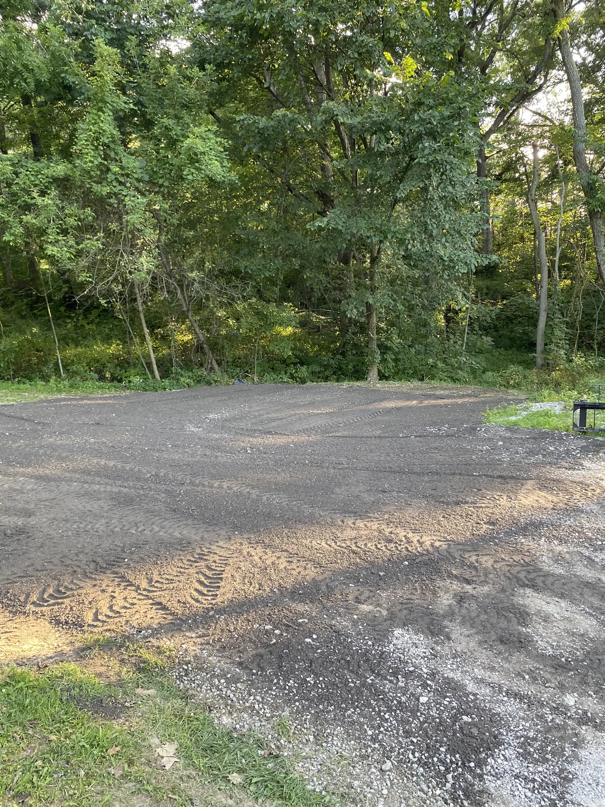 Finished millings parking pad packed along the woods